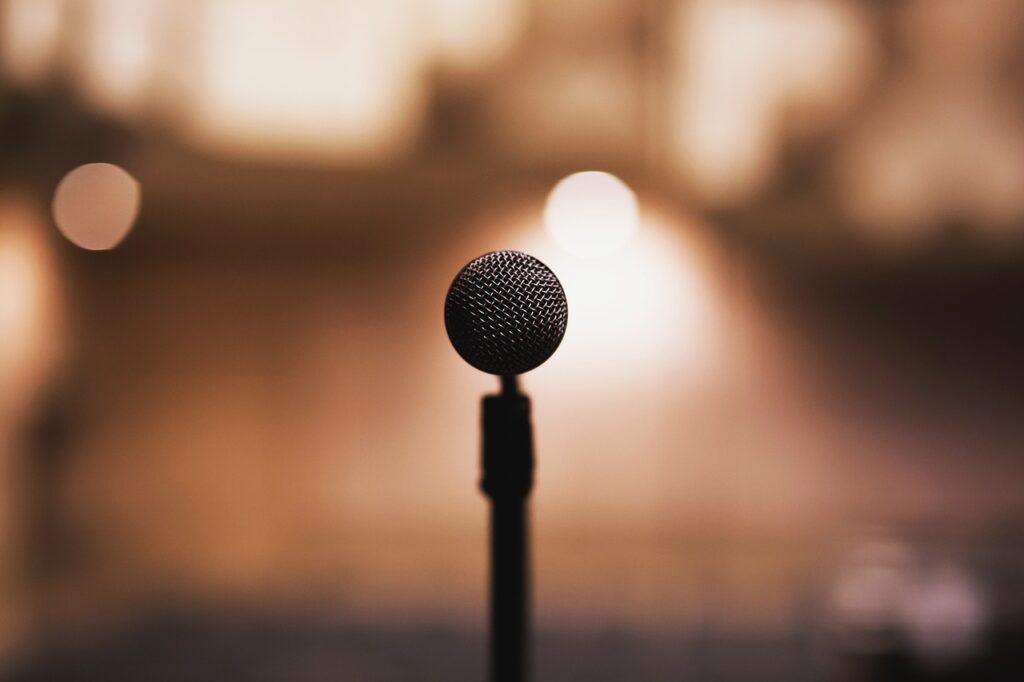 microphone on stand with blurred stage lighting in background